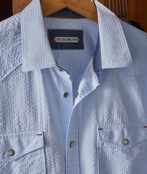 Take It To The Sky, a white textured button-up shirt with chest pockets and snap buttons.