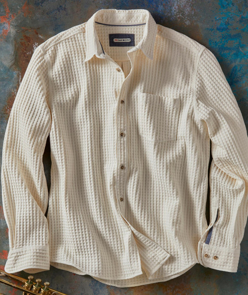Product Dug Up A Diamond, cream-colored textured button-up shirt with a single chest pocket and long sleeves laid flat on a rustic surface.