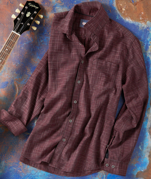 Do Your Own Thing, maroon plaid button-up shirt with a front pocket, laid on a textured multicolored background with a guitar partly visible.
