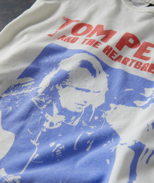 Into The Great Wide Open T-shirt, close-up of a vintage-style graphic with a woman's face in blue and red text design.