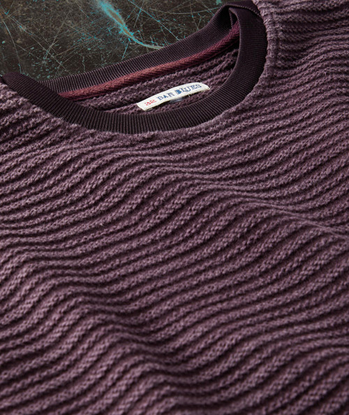 New Thing Now, close-up of a textured purple sweater with a ribbed neckline and a label that reads 32 Bar Blues.