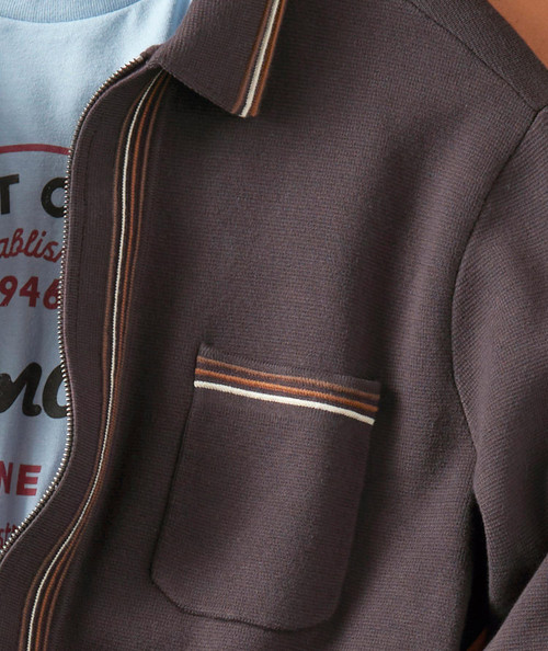 Time Change, close-up of a men's brown textured jacket with a pocket and striped trim details.
