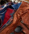 32 Bar Blues Quicker The Better, close-up of a brown leather jacket with zipper details and sunglasses placed on top.