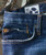 32 Bar Blues No Better Than This - Medium Indigo, close-up view of denim jeans showing pocket, stitching, and label.