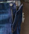 32 Bar Blues No Better Than This - Medium Indigo, close-up of denim jeans showing zipper and button details.