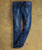 32 Bar Blues No Better Than This - Medium Indigo jeans, dark blue denim with fading and whiskering, laid flat on a textured brown surface.