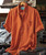 32 Bar Blues The Happiness Man, orange casual short-sleeve button-up shirt hanging on a wooden hanger in a music studio setting.