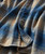 32 Bar Blues Reminds Me, close-up of a plaid shirt with blue and tan colors, showing buttons and fabric texture.