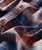 32 Bar Blues Morning At Midnight, close-up of a plaid shirt fabric with blue and orange checkered pattern and buttons.