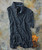 32 Bar Blues Samba Blue, a striped men's polo shirt with a collar and buttons, laid flat on a textured surface with some vintage game cards nearby.