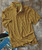 32 Bar Blues Samba Blue, striped yellow and blue polo shirt on a textured surface with vinyl records nearby.