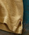 32 Bar Blues Sweet Tooth, close-up image showing a textured yellow fabric with red stitching detail.