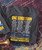 Product 32 Bar Blues Let's Do It Again T-shirt, gray T-shirt with yellow and white text listing jazz artists and sponsors for an emergency fund event.