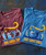 32 Bar Blues Let's Do It Again, colorful band t-shirts for music celebration, featuring illustrations of musicians and bold text celebrating the 20th anniversary of a re-release.