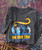 Product 32 Bar Blues Let's Do It Again, dark gray T-shirt with a colorful graphic of a jazz band and text celebrating the 20th anniversary re-release.