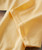 32 Bar Blues Ballad Of A Thin Man, close-up image of a soft yellow fabric with detailed stitching.