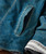 32 Bar Blues Just Like That, close-up of a blue denim jacket with a pocket and detailed stitching