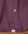 32 Bar Blues Berry Pickin' shirt, close-up of maroon fabric showing a button and a small white tag with red '32' label at the bottom hem.