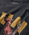 Product 32 Bar Blues Rooster Rock T-shirt, close-up of a black T-shirt featuring a vintage-style rooster graphic with the number 32 and the text 'Bar Blues Rooster Rock'.