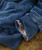 32 Bar Blues Beef Stew Blues, close-up of blue denim jeans with cuff turned up revealing patterned interior fabric.