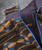 32 Bar Blues You Flip Me, close-up of a cozy, multicolored textured fleece jacket with a blue zipper and black interior lining.