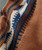 32 Bar Blues Coffee Grindin' Blues, close-up of knitted fabric with brown, blue, cream, and white patterns.