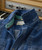32 Bar Blues Cut Me In, Denim shirt with quilted pattern and label inside collar on a vintage keyboard background.
