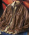 32 Bar Blues Fast As You Can, brown leather jacket with woven leather panels and multiple zippered pockets.