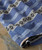 32 Bar Blues Hey Hey Hey Hey, close-up image of a blue patterned fabric fabric with black and white decorative stripes.