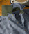 32 Bar Blues Stepping Up In Class, close-up of a stylish, textured men's dress shirt featuring a contrasting green collar and button-down front, positioned on a wooden surface.
