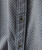 32 Bar Blues Follow Me Up - Charcoal, close-up of a stylish charcoal-colored shirt with a herringbone pattern and black buttons.