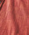 Better All The Time, close-up of textured red and orange woven fabric of a garment.