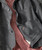 Easy Way Out, close-up of a dark gray sport coat with decorative buttons and a red patterned fabric shirt underneath.
