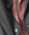 Easy Way Out, close-up of a dark gray sport coat with decorative buttons and a red patterned fabric shirt underneath.
