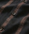 Midnight Jump, close-up of black fabric shirt with brown intricate geometric pattern, buttons, and stitching details.