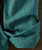 Bluegrass Break Up, close-up of a textured, patterned teal-green towel or fabric with a small pocket.