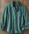 Bluegrass Break Up, green textured casual button-up shirt with a front chest pocket hanging on a wooden background.