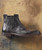 Night Train, black leather men's ankle boot with elastic side panels on a rustic wooden background.