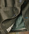 Better Ways, Close-up of olive green jacket with inner pocket, button detail, and contrasting inner lining.