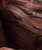 Destination Anywhere, close-up view of the brown leather backpack interior showing the brand label, zippered pocket, and compartments for organization.