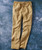 Step To It, beige casual drawstring pants with large front pockets on a blue textured background.