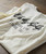 Sunrise On Sunset T-shirt, white short-sleeve casual T-shirt with printed text about Riverside, California, on a wooden surface.