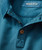 Get A Better One, close-up of the collar and buttons of a blue textured dress shirt.