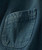 Blazin' product, close-up of a dark denim fabric pocket on a jacket or shirt.