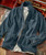 Blazin' denim jacket, stylish dark blue denim jacket with buttons and multiple pockets, placed on a rustic surface near a vintage trumpet case.