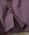 Twilight Time, close-up of a purple striped shirt with wooden buttons and embroidered musical note logo.