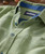 Blue Tango, close-up of a men's patterned button-down shirt with green and blue colors, featuring blue buttons and a contrasting collar detail.