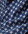 Got My Plans Squared Away, close-up of navy blue fabric with white embroidered geometric pattern and a button detail.