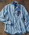 Buzzy, stylish men's striped long-sleeve shirt with sunglasses placed on the chest pocket, laid on wooden surface.