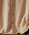 Break It Up, close-up of a beige checkered textured shirt with brown buttons.